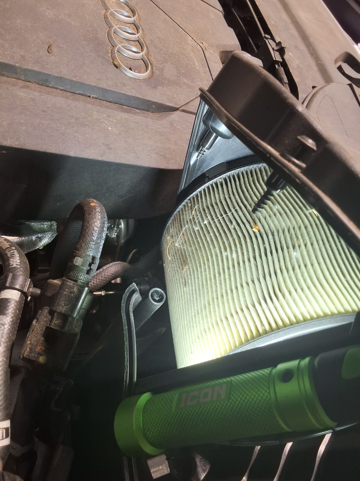 Engine air filter being inspected on an Audi Q5.