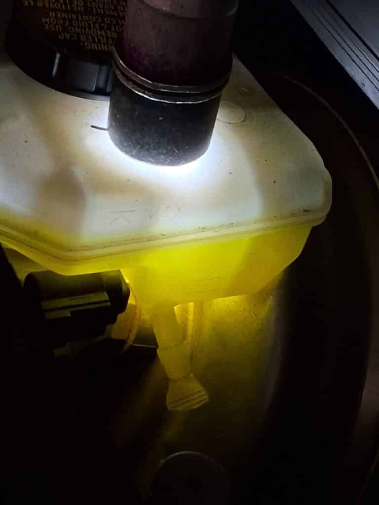 Brake fluid reservoir being inspected on an Audi Q5.