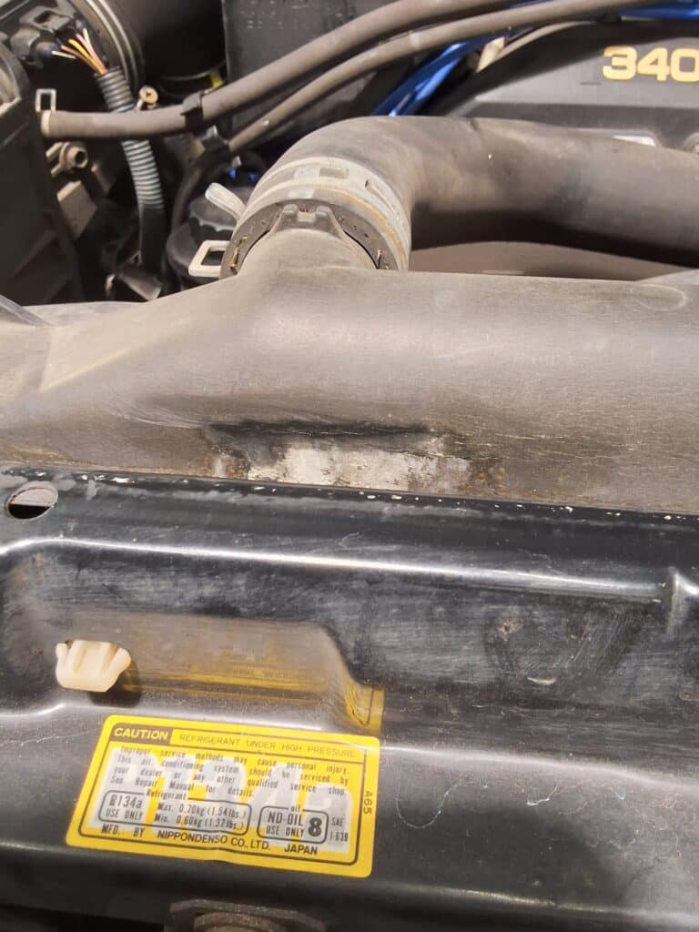 Cracks visible in the plastic radiator tank on a 1996 Toyota 4Runner.