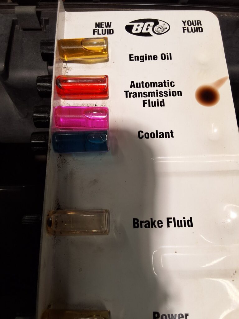 Automatic transmission fluid condition checked during inspection of a high mileage Toyota 4Runner.