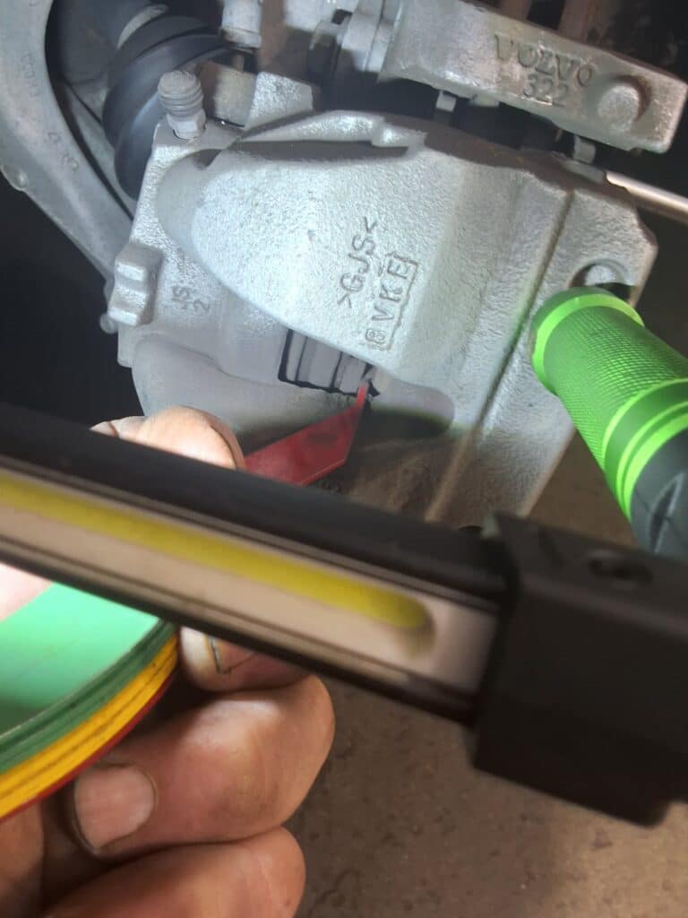 Front brake pad thickness being measured on a 2019 Volvo XC60.