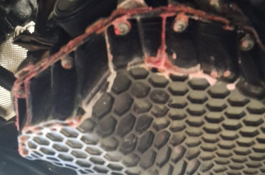 Dried pink coolant residue visible underneath the engine area of a 2021 Volkswagen Tiguan.