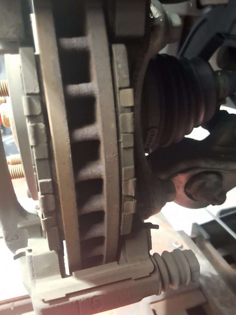 Front brake components on a Lexus IS250 during inspection at 34th Street Garage.