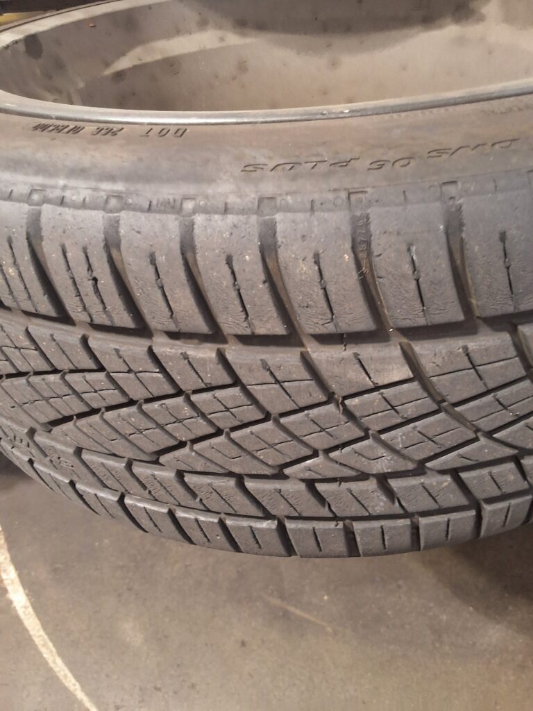 Inside edge tire wear visible on a Lexus IS250 during inspection