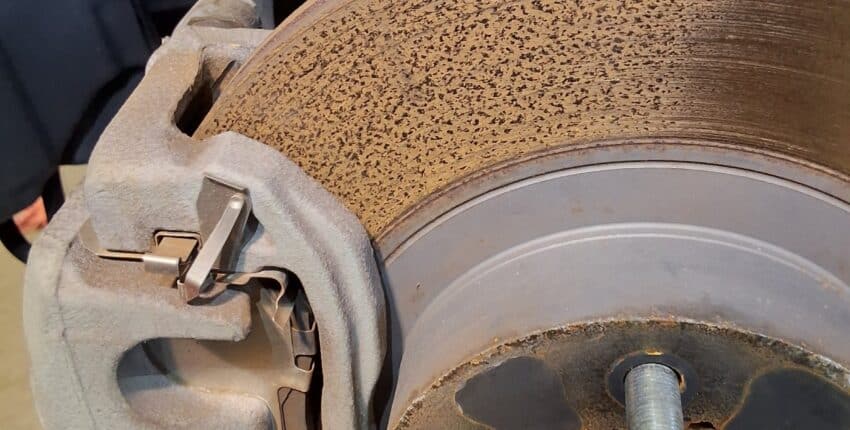 Rusted and pitted front brake rotor on a Scion FR-S during inspection