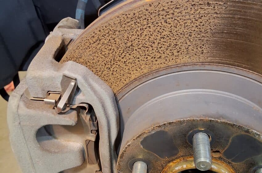 Rusted and pitted front brake rotor on a Scion FR-S during inspection